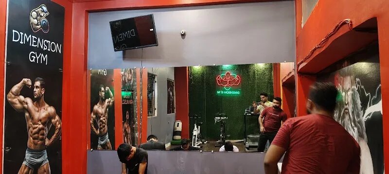 Wide hall with a mirror wall and neon logo on a green wall
