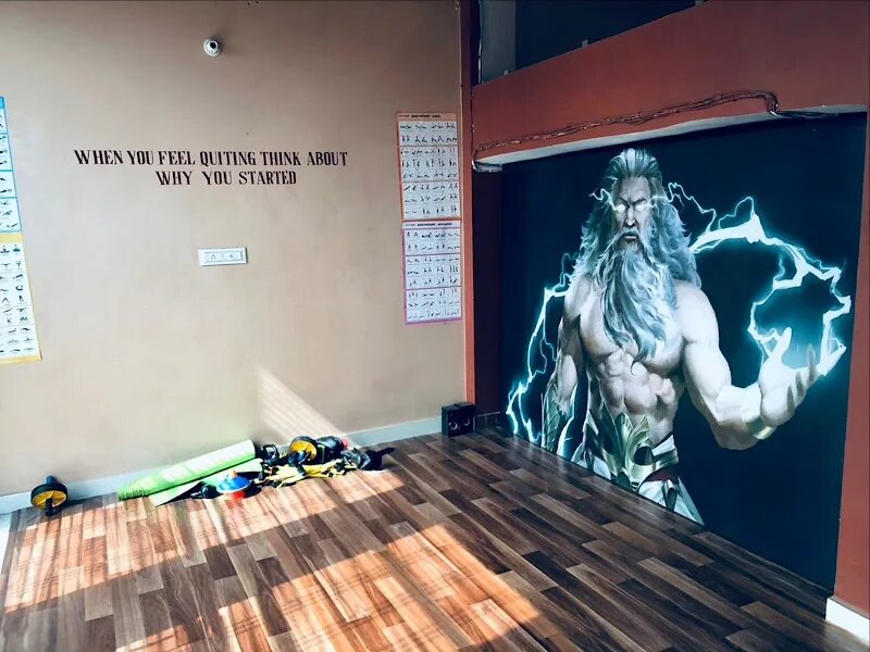 Stretch zone with wood floor and a Zeus mural